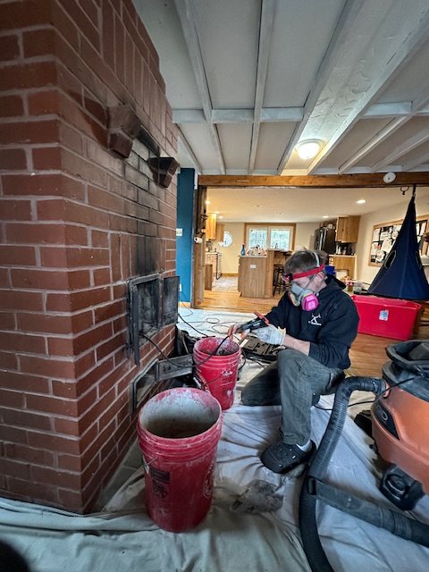 Master mason at work on a brick chimney